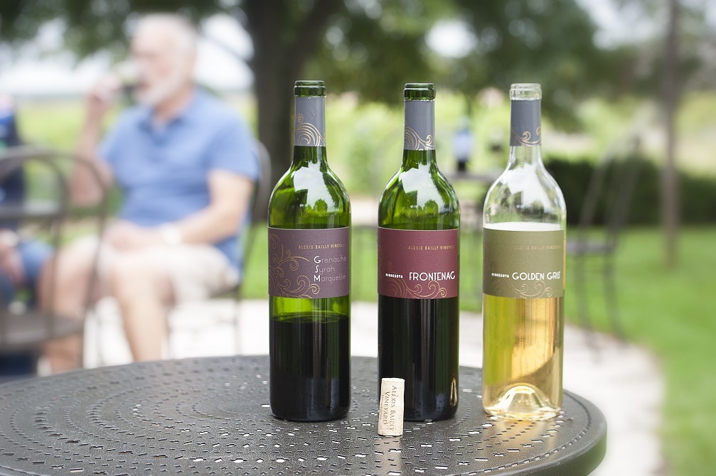 Three bottles of wine on an outdoor table