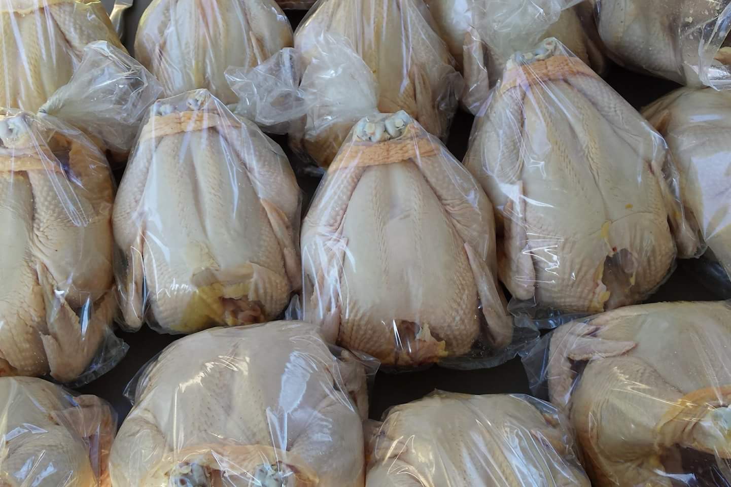 whole chickens in plastic wrap