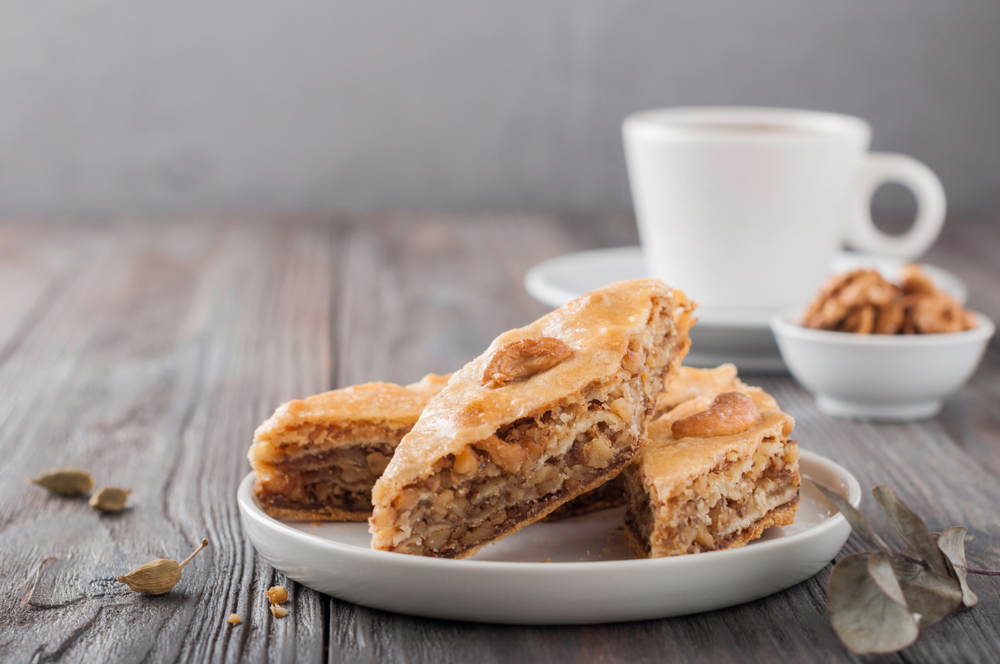 baklava on a plate with a coffee