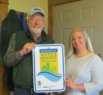 Mike holding the MN Ag Water Quality Sign