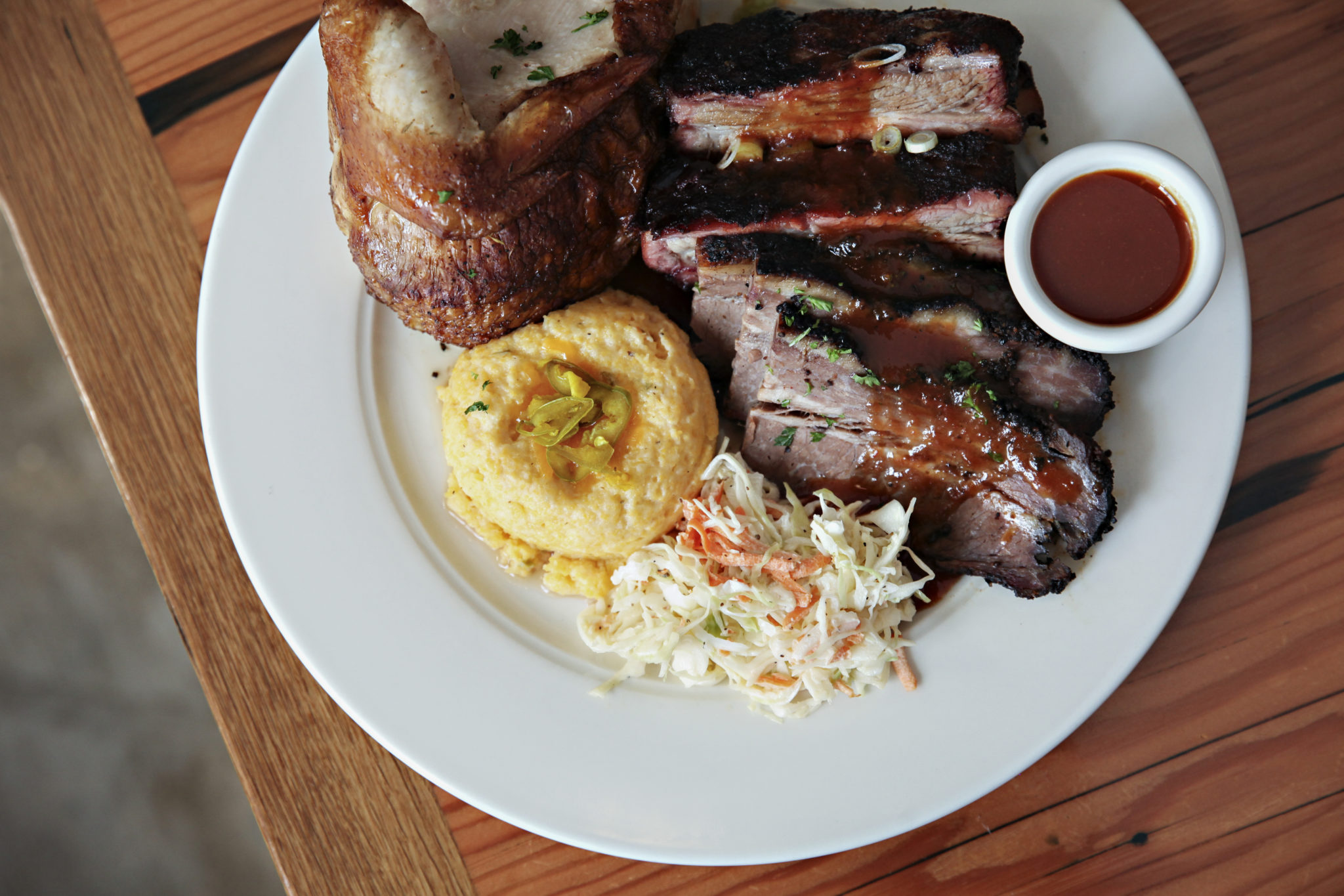 Barbeque ribs, chicken and coleslaw on a plate