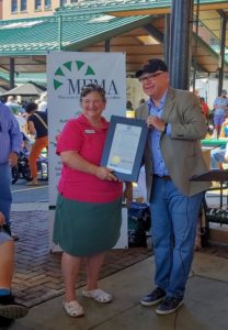 National Farmers Market Week 2019 declaration being held by Kathy Zeman and Governor Walzby 