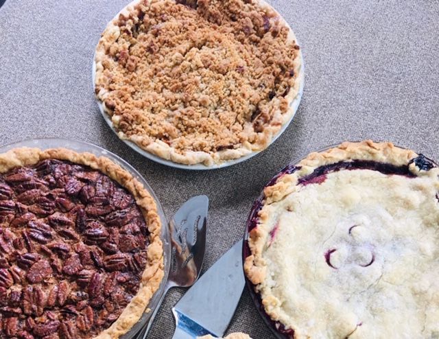 three fruite pies - apple crumble, pecan, and blueberry