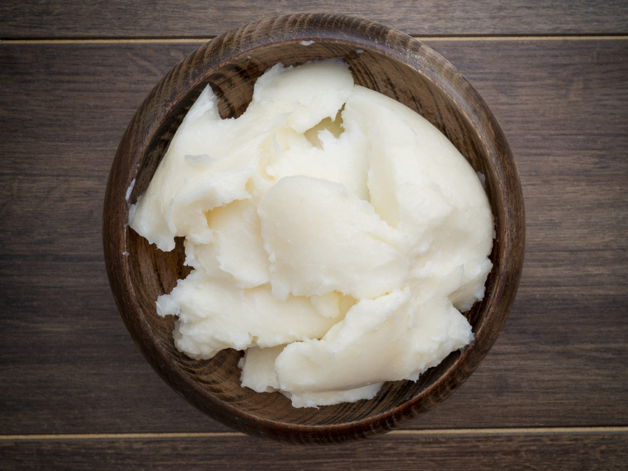 Lard in a bowl on dark rustic background