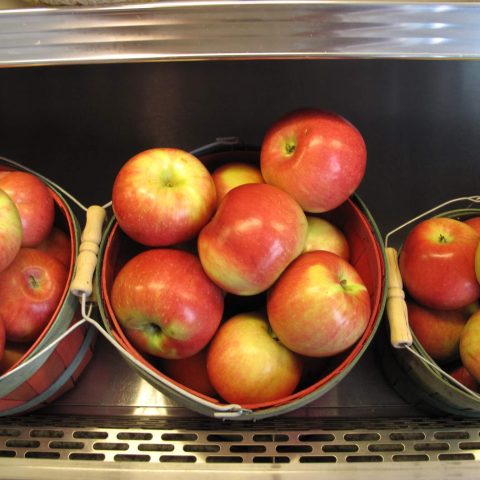 Closeup of three baskets of honeycrisp apples