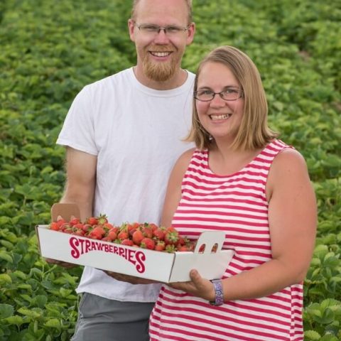 Nowthen Berries family posing in strawberry field.