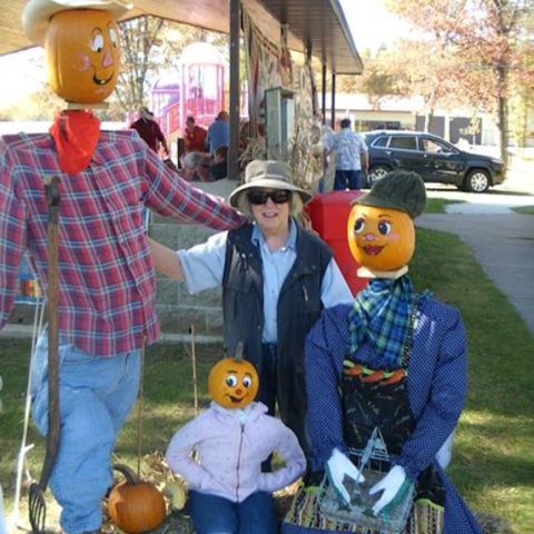 Scarecrows with a market vendor