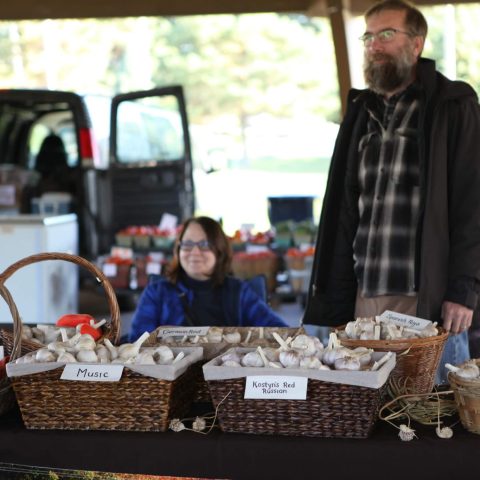Winter market garlic vendor waiting for customers