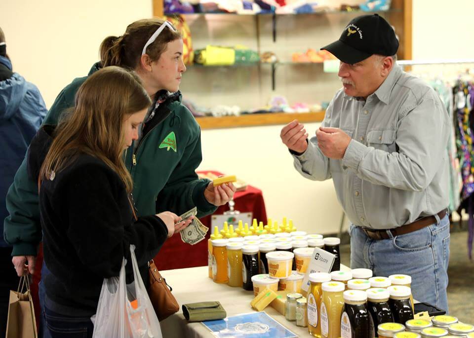 Honey farmer talking with guests