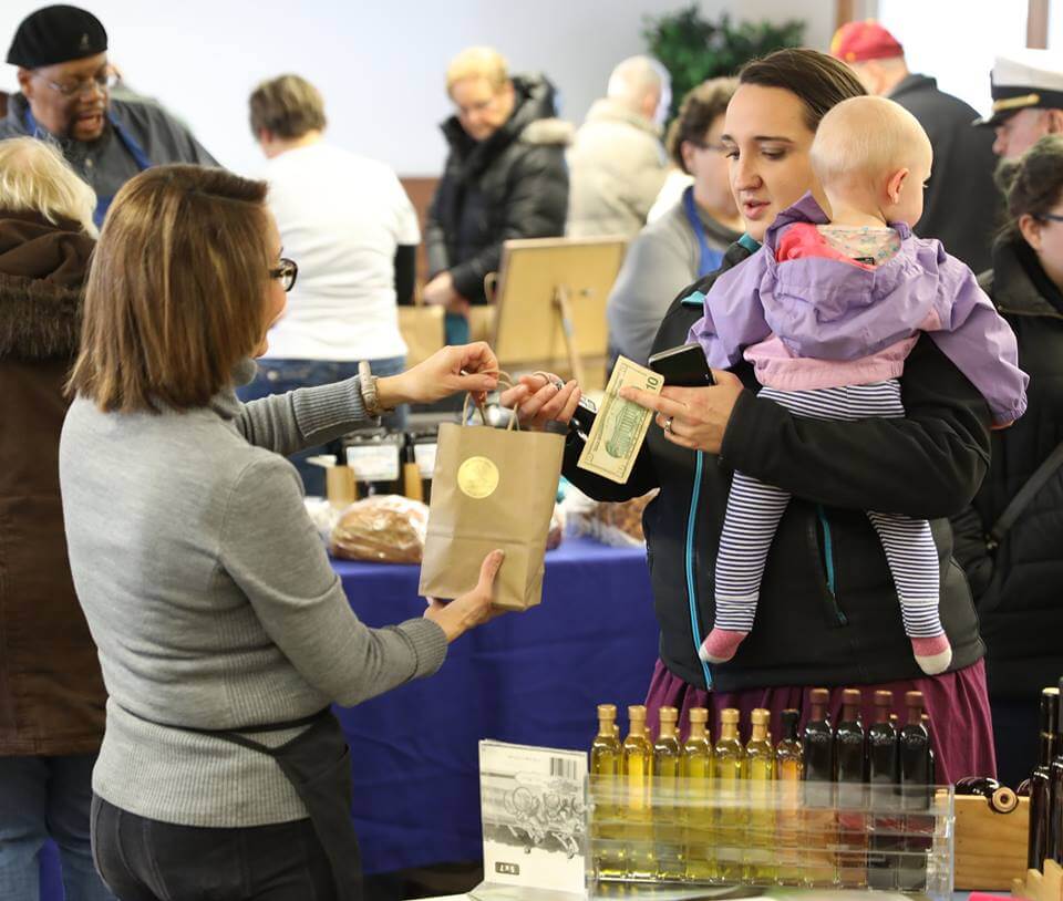 Vendor with baby buying oil