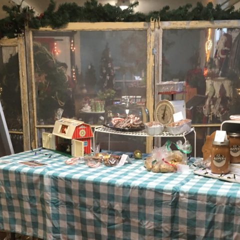 Roper Farms vendor table at a farmer's market