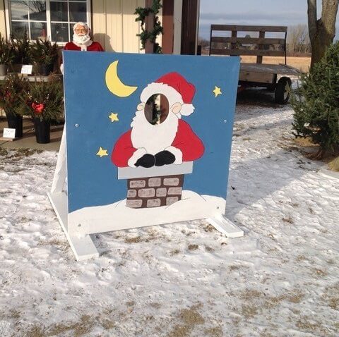 Santa themed photo opportunity with head cutout for visitors
