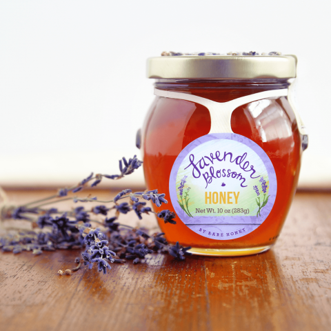 lavender honey posed with lavendar on wood table