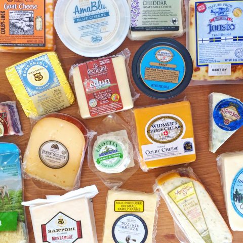 Large array of cheese products on a wooden table