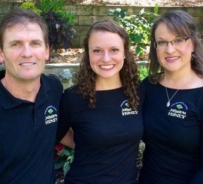 Three family members wearing navy company shirts