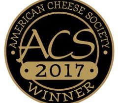 American Cheese Society Winner award logo. It is a black circle with gold words.