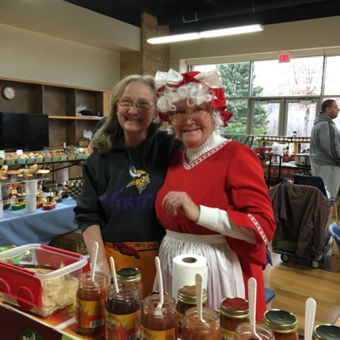 Mrs. Clause standing with a vendor