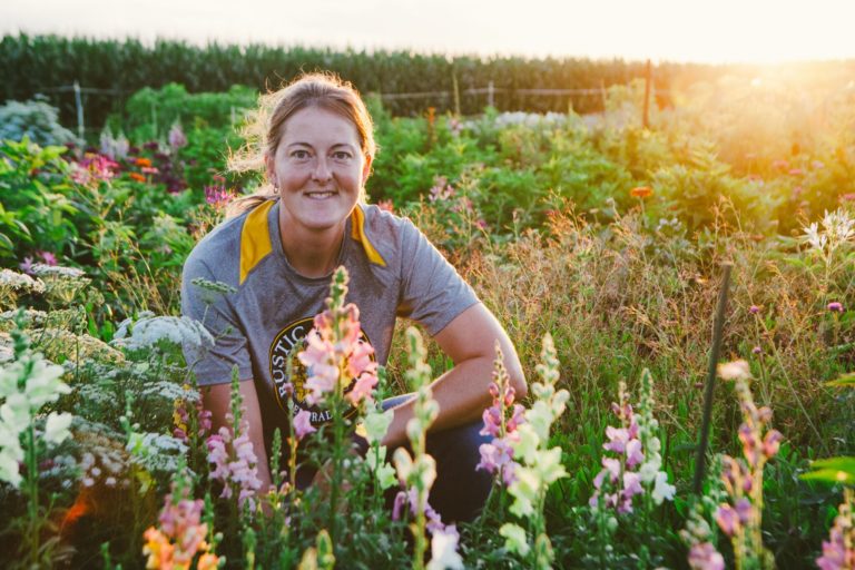 woman sitting in flower bed