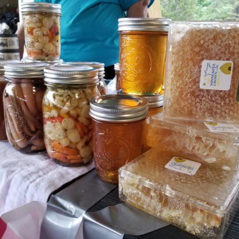 honey and comb for sale along with pickled vegetables