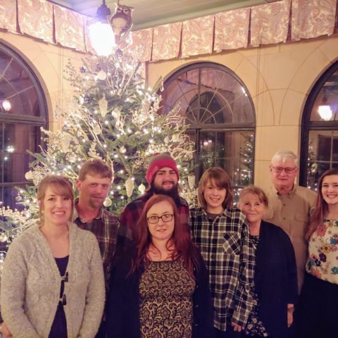 family photo in front of Christmas Tree