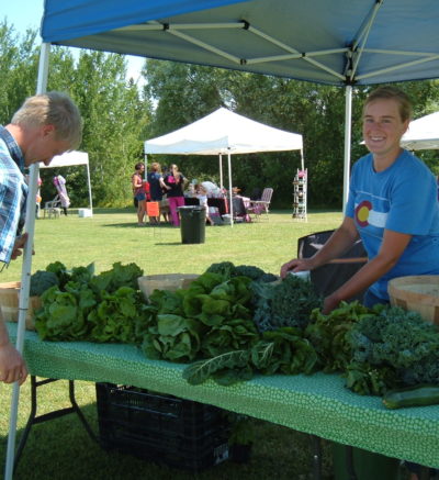 customer looking at lettuce vendors produce