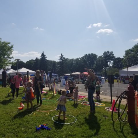 children playing with hoola hoops at the farmers market