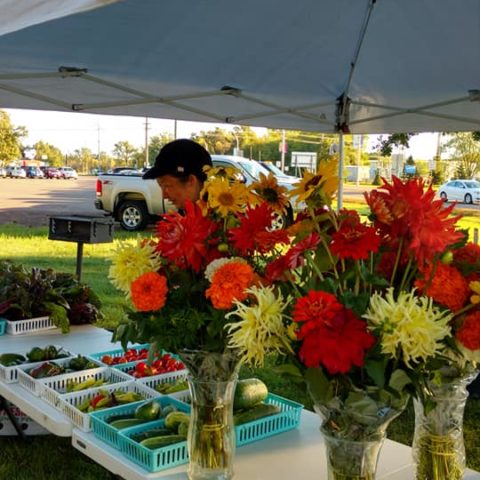 vendor selling red and yellow flower bouquets