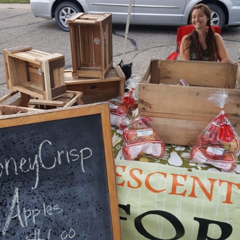 A woman sitting at her booth