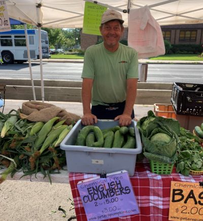 Co-owner, Peter, at his farmers market booth