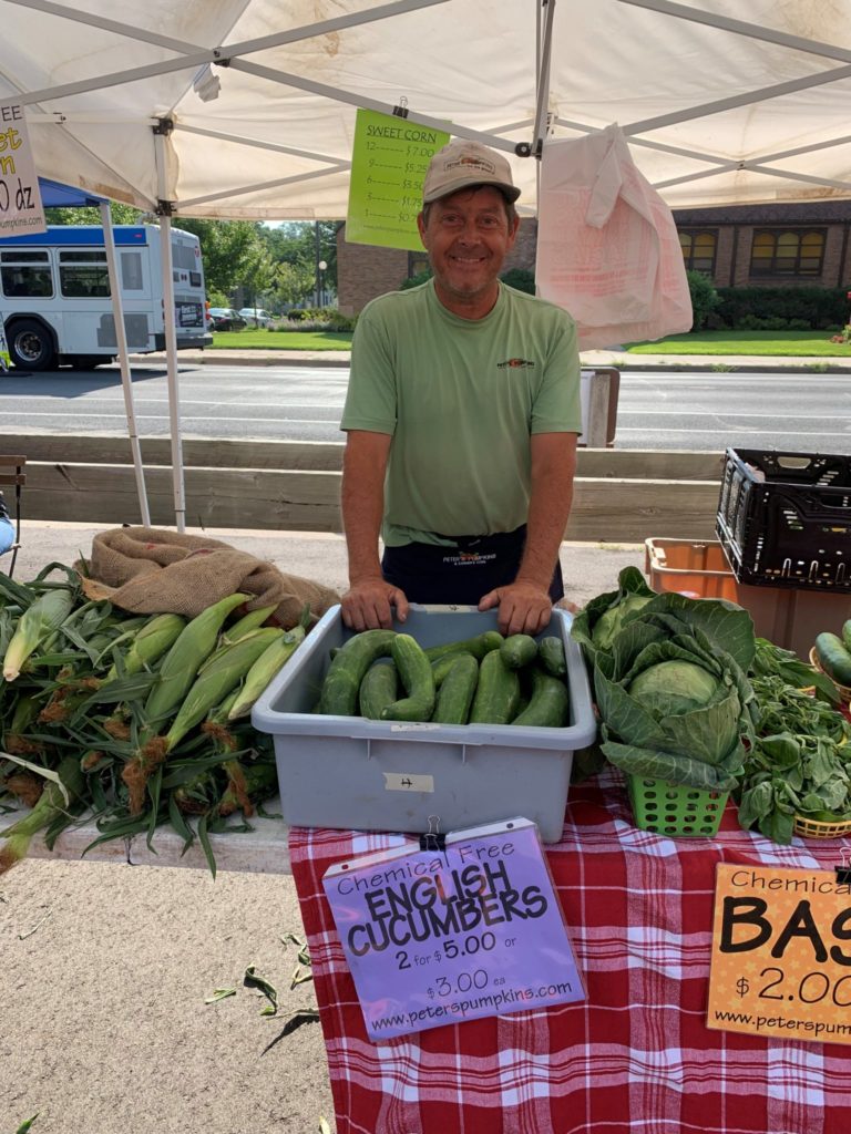 Co-owner, Peter, at his farmers market booth