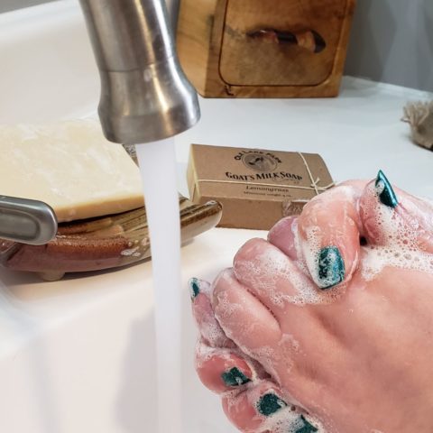 woman washing hands with goat milk bar soap