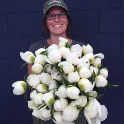 Farmer holding white flowers