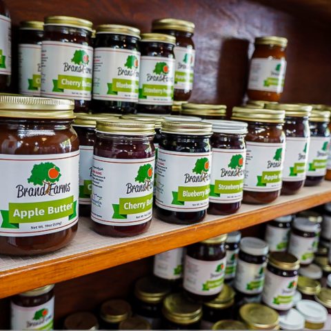 Shelves of Brand Farms apple butter and an array of jams.