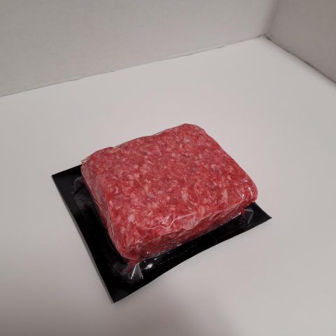 Packaged ground, raw meat in a square.