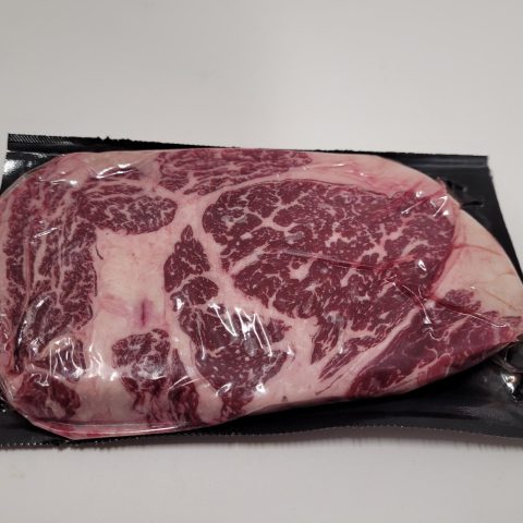 Large cut of red meat packaged.