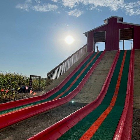 A giant slide at an apple orchard.