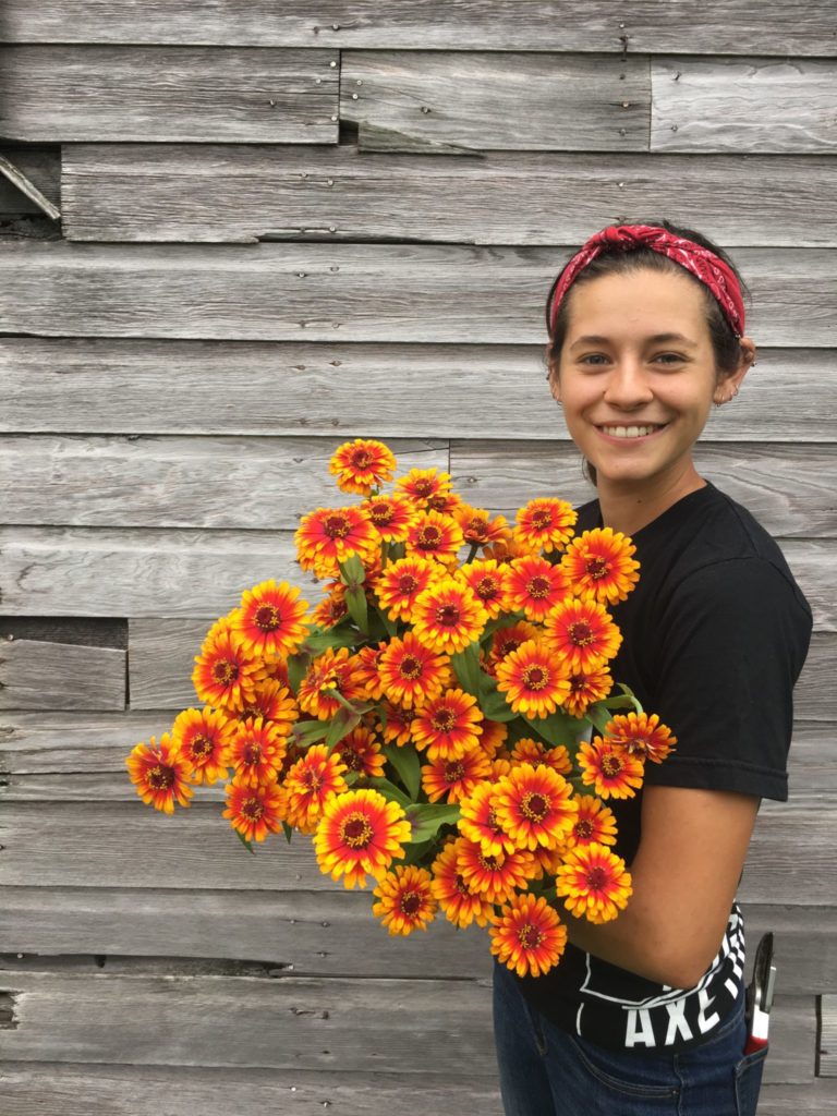 Woman holding yellow and orange flowers