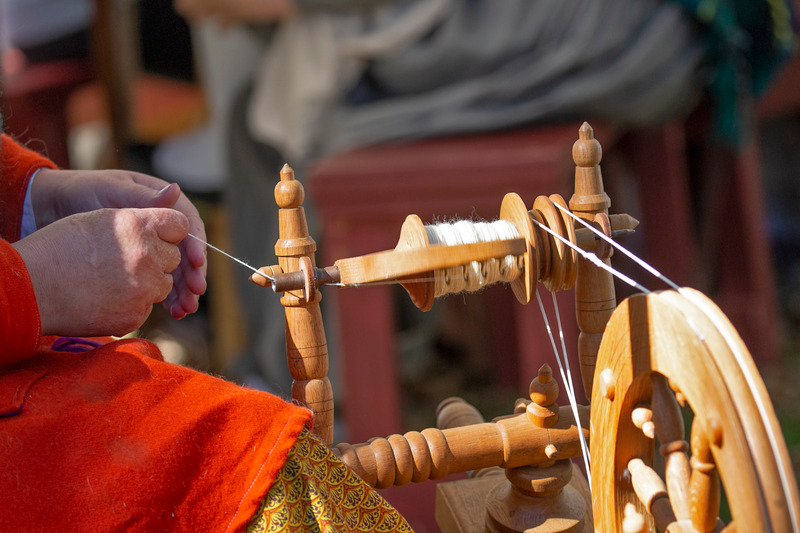 Female artisan spins yarn with spinning wheel | Minnesota Grown