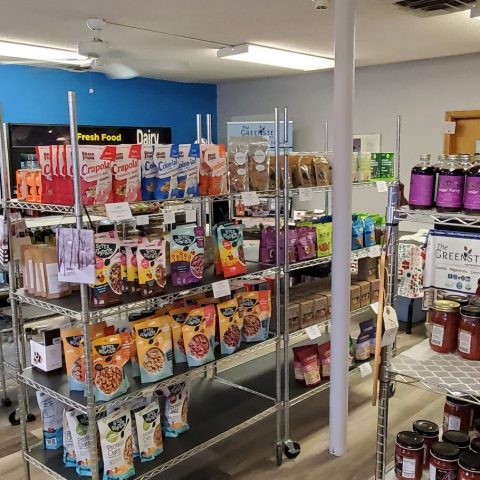 Picture of the Greensted store with metal racks loaded with miscellaneous foods.
