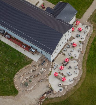 Overhead view of a winery with patio and vineyards.
