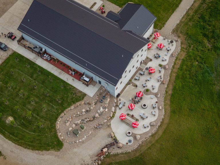 Overhead view of a winery with patio and vineyards.
