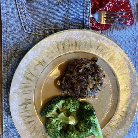 Bison burger with caramelized onions and broccoli