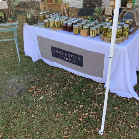 Lazy Toad Farm farmers' market stand with jars of pickles on it