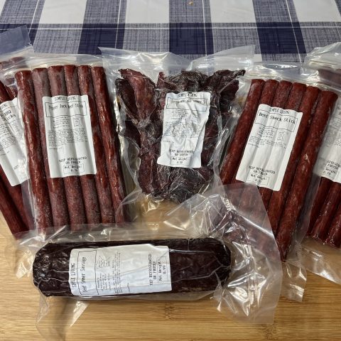 A picture of multiple packages of meat/beef sticks, summer sausage, and meat/beef jerky.