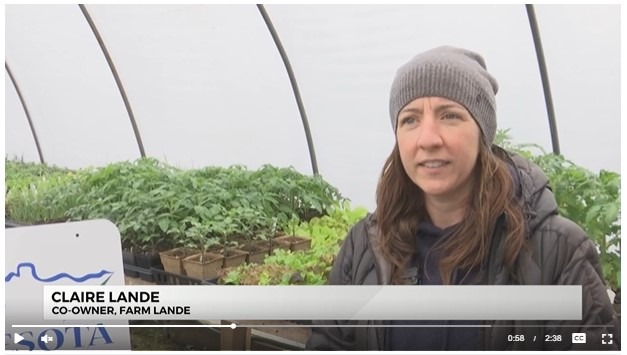 A female farmer in her greenhouse speaking about planting season.