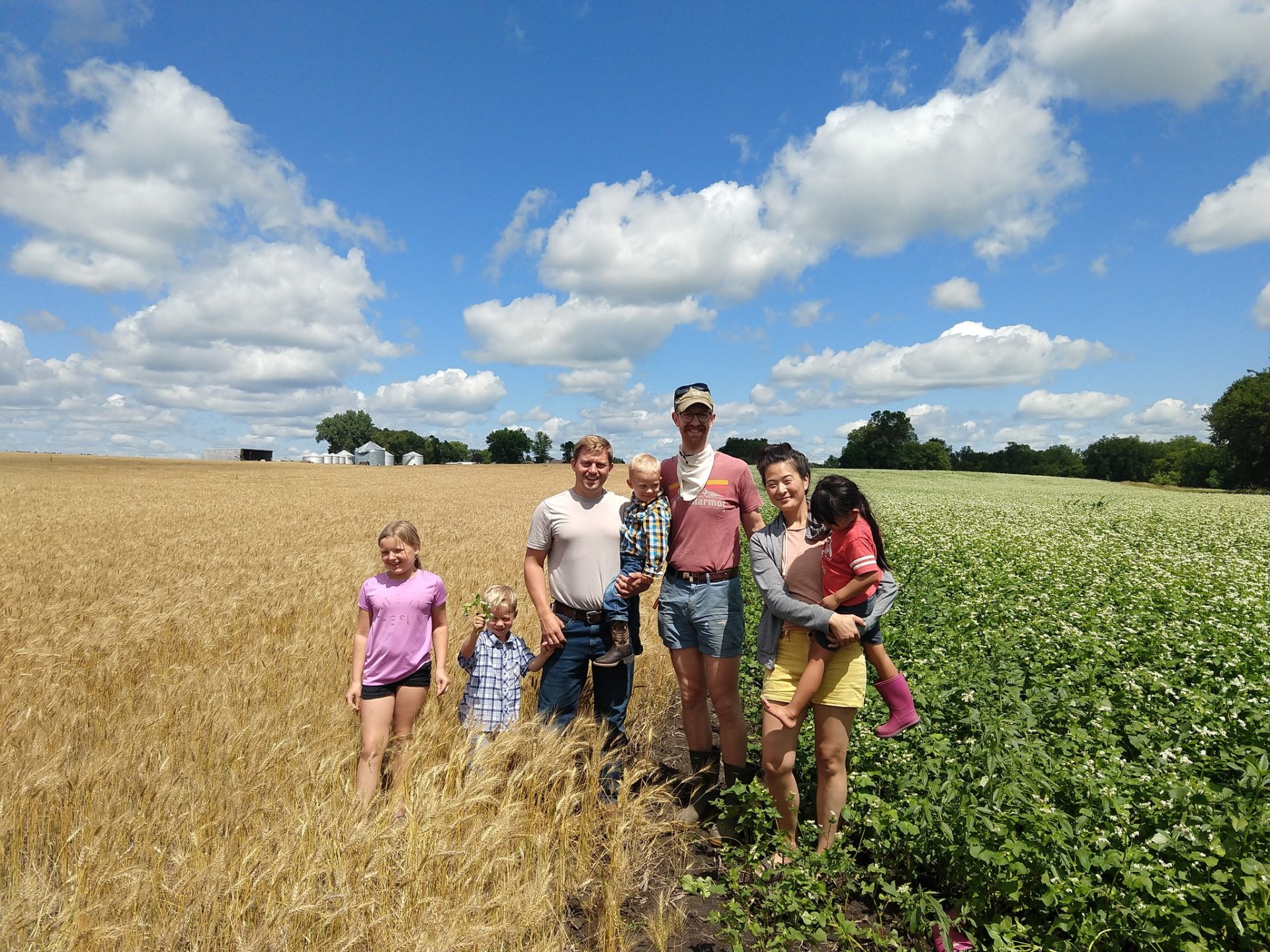 A family with children in a field.