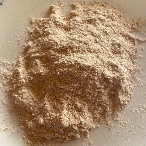 Loose light brown flour on a counter