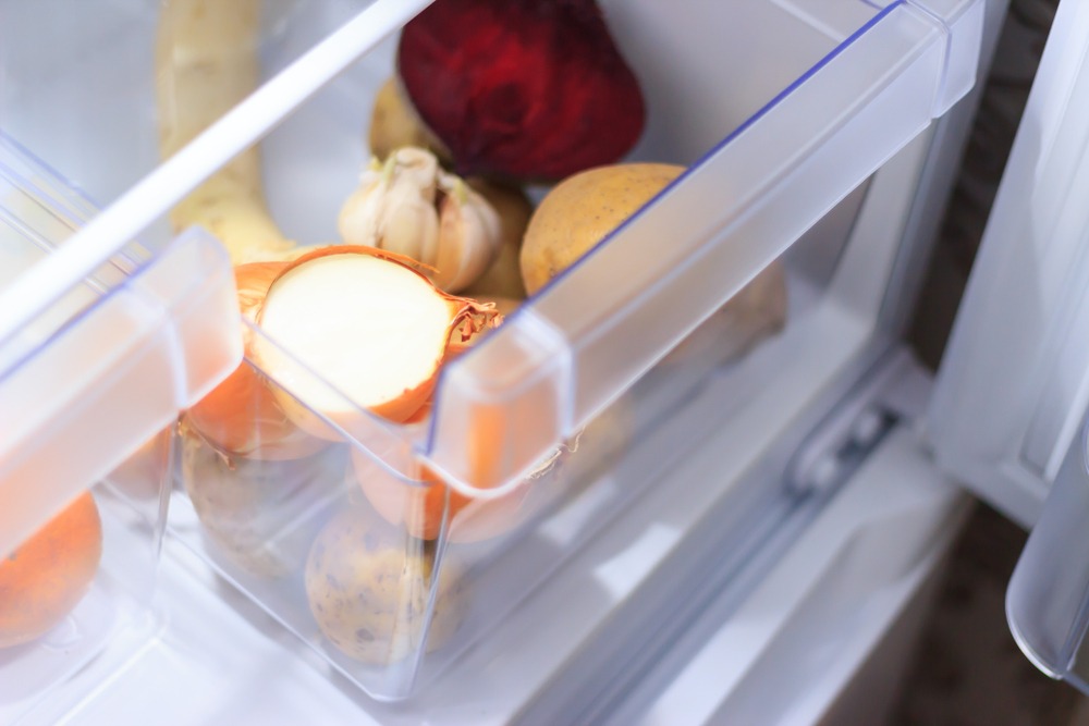 Vegetables in Open Fridge Crisper Drawer Onion Garlic