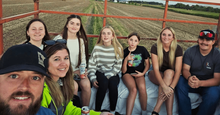 A family of farmers on a haywagon.