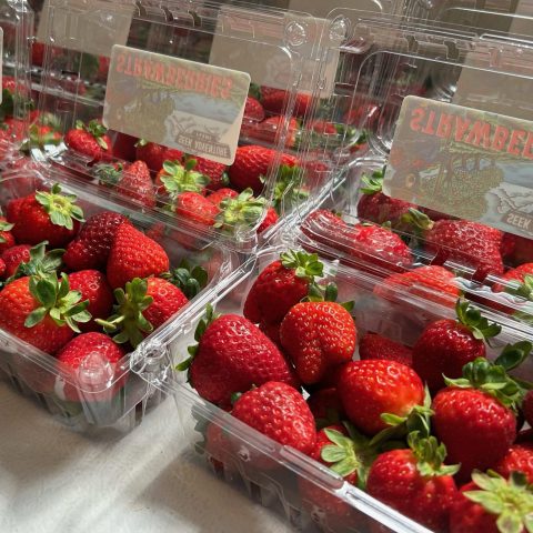 Picture of a few plastic containers of strawberries.